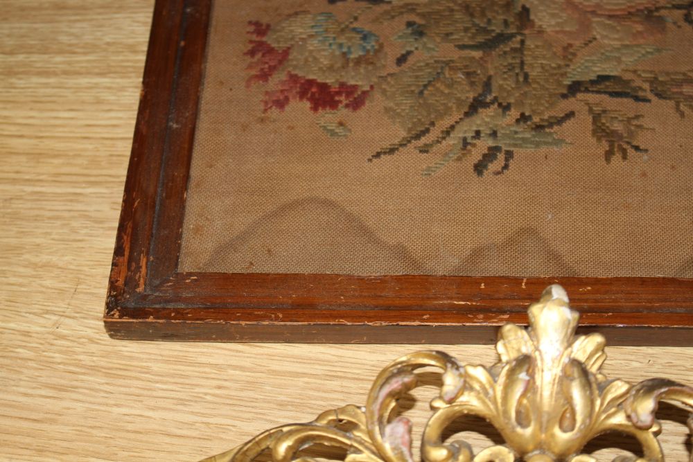 A gilt framed oil portrait of a young lady signed E. Reilly, diameter 22cm, overall 40cm, and two woolwork floral panels, 37 x 26cm